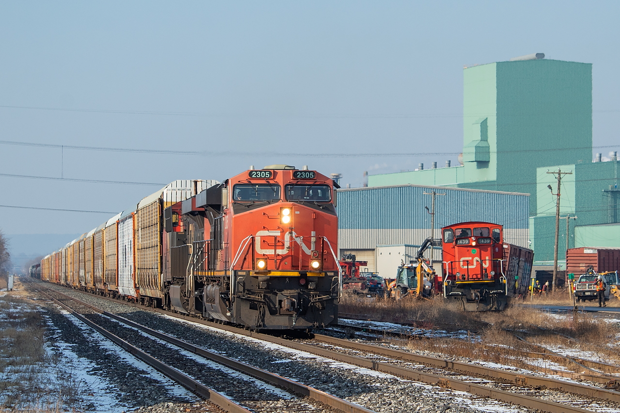 With the previous day's 330 rolling past the cleanup of a two-day old derailment, I don't think CN will be asking to use this image to demonstrate operational excellence anytime soon. The story here - 555, operating with the triple set, put some boxcars on the ground in Parkdale Yard on Friday night. By the looks of it, the 0800 crew was dispatched with the double set on Sunday morning to help with the cleanup. When 300 got to Hamilton Sunday morning, the yard crew working in Stuart asked if they were really early or really late. The answer was that they never even left Sarnia on Saturday on account of not having a crew, and didn't leave until early Sunday morning. Before this shot, a couple of follies compounded the situation - 330 was stopped completely in Parkdale Yard for a good 20 or 30 minutes, sitting in the approach to the crossing and completely fouling traffic on Parkdale Ave. Meanwhile, it looked like the cleanup crew had the boxcar in the image back on the rails and went to pull ahead, only to put it back on the ground with a bang.