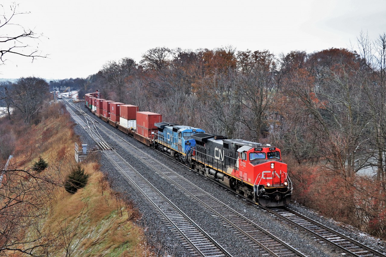 A pair of IC units in IC 2702 and IC 2455 in two different paint schemes lead CN 148 through Bayview Junction as they head eastward. The dull dreary day didn't help but at least the light rain and snow ended.