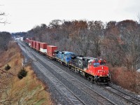 A pair of IC units in IC 2702 and IC 2455 in two different paint schemes lead CN 148 through Bayview Junction as they head eastward. The dull dreary day didn't help but at least the light rain and snow ended.