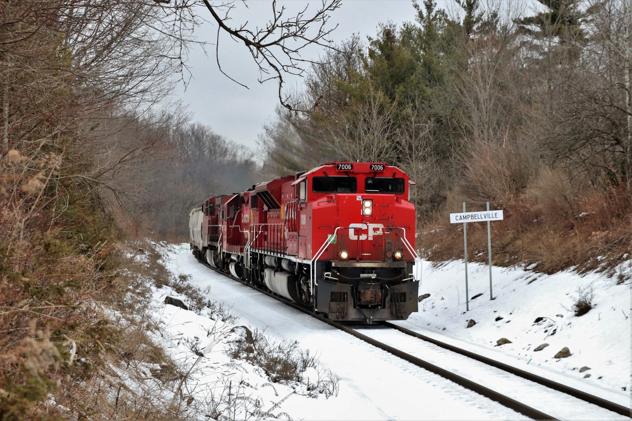 I was sitting in my usual spot waiting for an early CP 140 when my phone rang. Mr. Host informed me that CP 246 had a rebuilt CP 7006 leading. Well every other effort to get one of these rebuilds has ended up broke down, or trailing, so off I went to Guelph Junction. I shot CP 140 so I sat wondering where to get the CP 246 and I recalled looking at Arnold's picture earlier in the day. A few things changed with the "Guelph Junction" sign replaced by the "Campbellville" sign, the trees and foliage are a little higher and grown in and there are gates on the crossing just behind me but the spot is a very good shooting location.
CP 7006 with CP 3063 and CP 8608 pour the power on as they head south down the Hamilton sub for a stop at Kinnear.