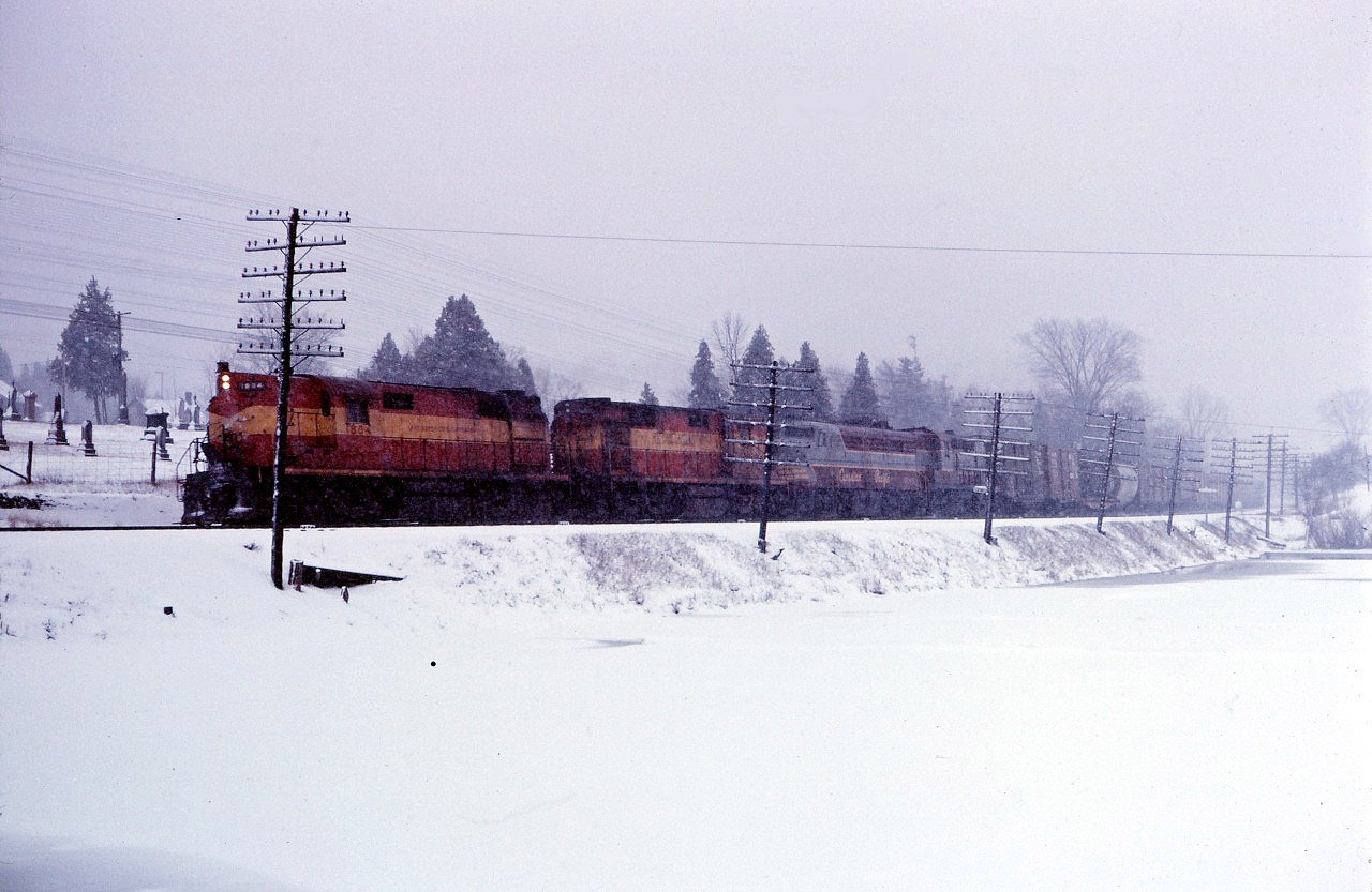 Over the winter of 1965-66, Canadian Pacific once again had many units on lease from railroads such as the Bessemer & Lake Erie, Boston & Maine, as well as the Lake Superior and Ishpeming. Here we see two of the LS&I's RSD12s (1804 and an unidentified unit) leading CP FPA2 4082 and RS10s 8593 east through Campbellville on a snowy day in early 1966.