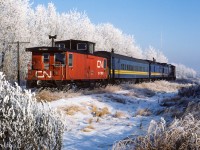 A photo to go with the upcoming season. This picture was taken at the same time, just a few minutes earlier, than my first posting of this frosty day. Please see http://www.railpictures.ca/?attachment_id=38412 for my initial frosty post and additional info on No.91. Same passenger train, but, from the other side and shot west of Redwater. I really love the view down the track. The edge of Redwater is not more than a half mile away (the large tower in the background is on the outskirts of town). Although it looks like there are trees in this area, these are actually just the few along the R/W. It is very much open with farms surrounding the town.