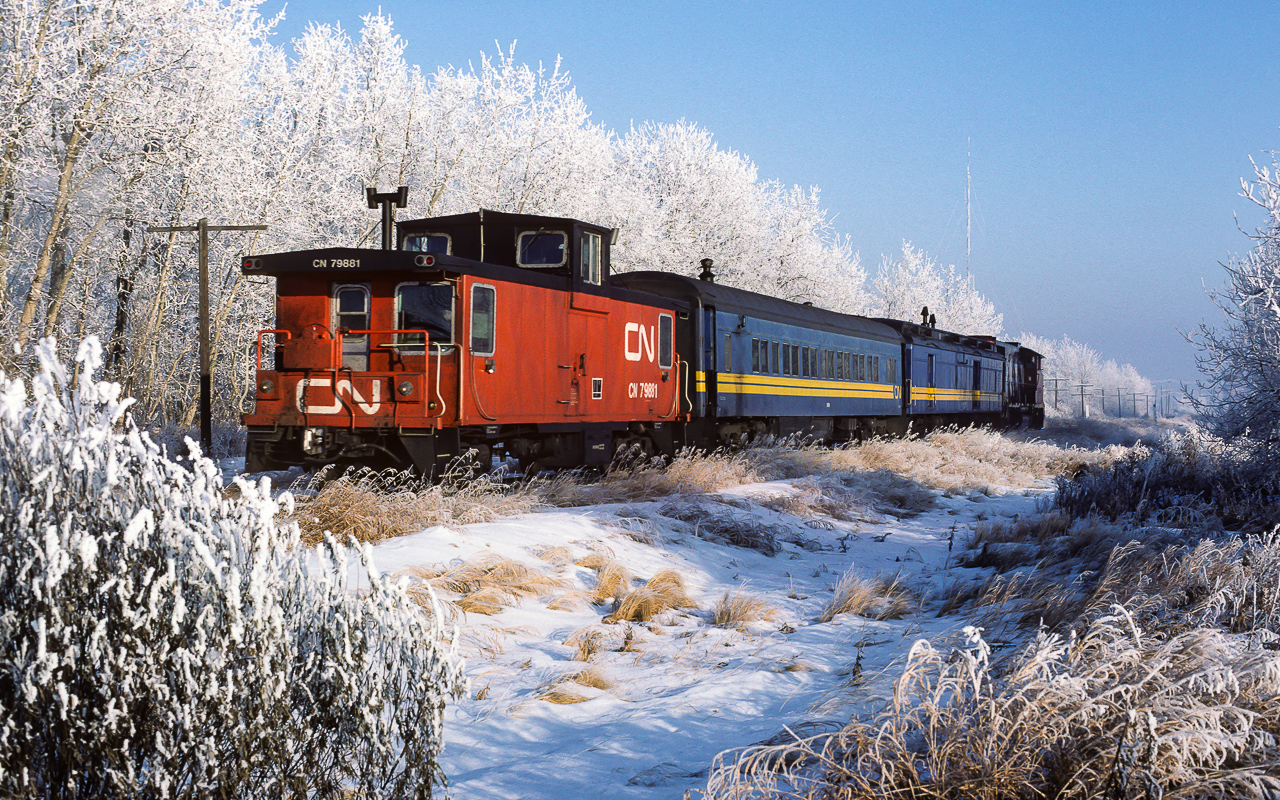 A photo to go with the upcoming season. This picture was taken at the same time, just a few minutes earlier, than my first posting of this frosty day. Please see http://www.railpictures.ca/?attachment_id=38412 for my initial frosty post and additional info on No.91. Same passenger train, but, from the other side and shot west of Redwater. I really love the view down the track. The edge of Redwater is not more than a half mile away (the large tower in the background is on the outskirts of town). Although it looks like there are trees in this area, these are actually just the few along the R/W. It is very much open with farms surrounding the town.