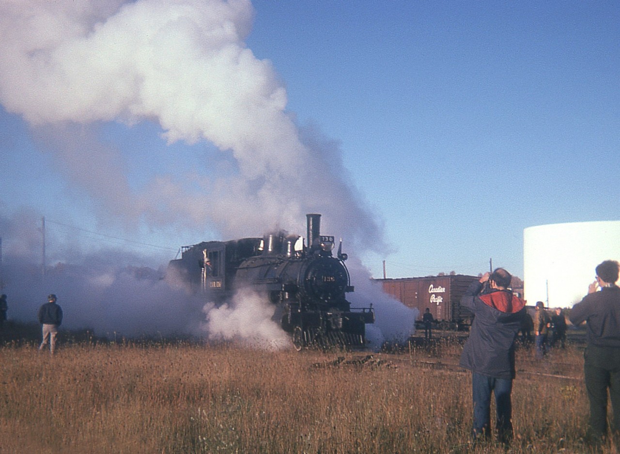 Beautiful sunny but very crisp icy morning in Owen Sound CP yard as the old CVR 136 4-4-0 Rogers steam engine (built 1883) is steaming up for the return trip south to Toronto as the second leg of the Toronto to Owen Sound Thanksgiving Weekend trip is about to get under way.
Time of photo is about 0730, the sun is just waking up as well.
This certainly was a memorial trip as what could go wrong did, on the return; resulting in us getting back to Toronto at some early hour, maybe 0400, maybe 0500; I really do not remember.  I just recall the article in the Toronto Star titled, "38 Miles in 11 Hours".  Something I would never forget, for I had to be at work at 0730 that morning in St. Catharines.
Why so late? Bad coal. And farmers fence posts just did not keep the steam up.
I'm sure everyone that went on this trip behind "National Dream" 136 and 4-6-0 #1057 will never forget it.
