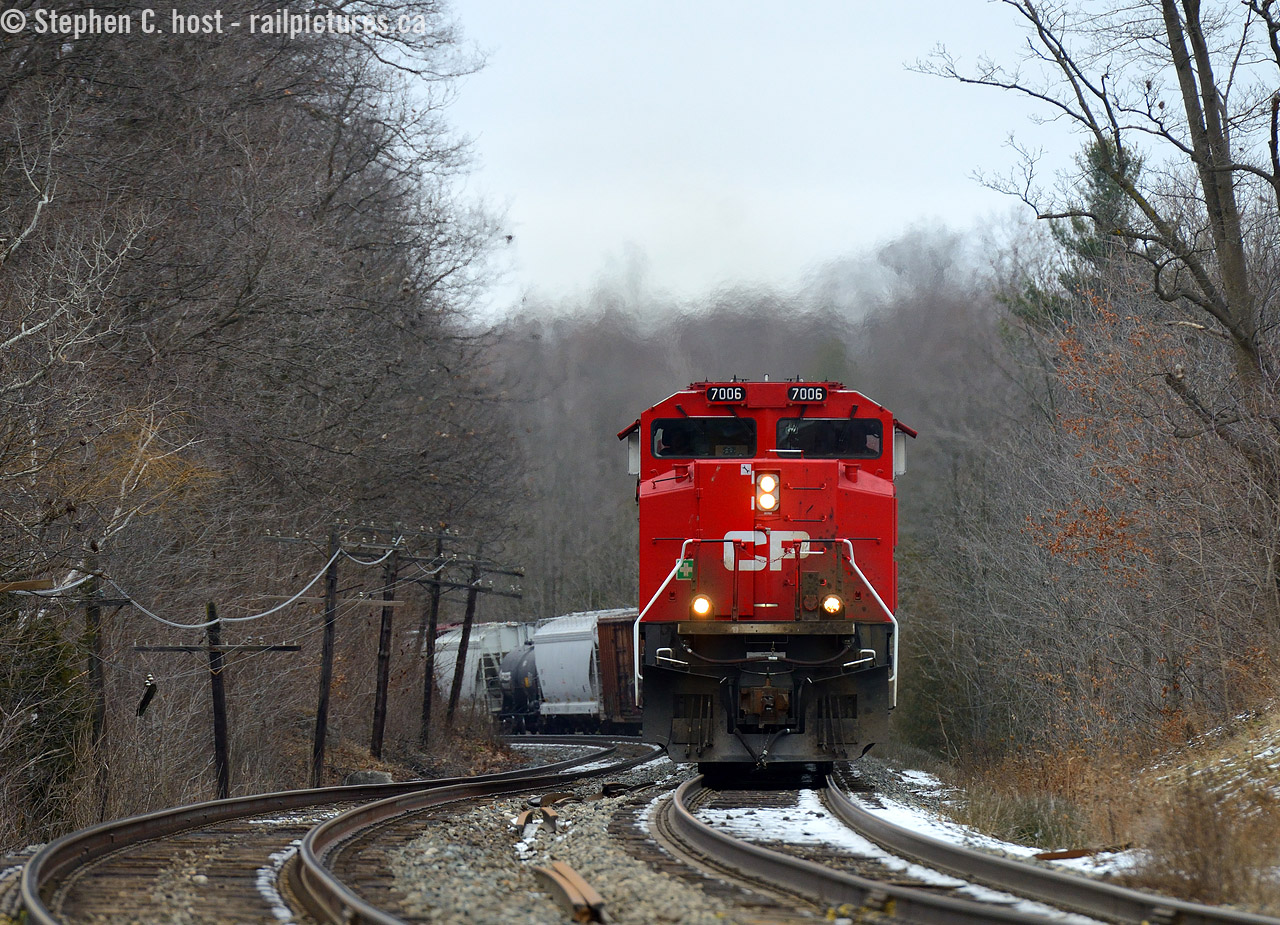 T'was Chistmas eve, not a creature was stirring, not even a mouse.  Until CP 7006 west came barreling through Campbellville like a bat out of hell - the fastest train I've EVER seen go up the grade and that includes light power! This was a 40 car train too. Talk about wanting to get home on time for Christmas (I don't blame the crew one bit). According to the RTC 246 had power problems (again) but managed to get going and gave the hill the show it hasn't seen in a long time. To boot - this train sounded nothing short of amazing, with the new EMD product in the lead, 3063 trailing and a GE of some kind in third, EMD was surely the dominant sound.br>
On that note - Merry Christmas from my family to yours - to all of our feller photographers, our volunteers who help make all these great photos get posted (all the back room photo editors, photo scanners, information/caption teams, moderators, database team, and social media butterflies) - all the railway employees in and outside the cab - and to all our viewers and fans all around the world, thanks for a great year and here's to many more. Wait, what about our Significant others that miss us all so much :) I forgot them. Hint: it's time to spend some time with them if you can :) but if you really don't want to, we'll have your company here :) Beers are the fridge. Cheers!