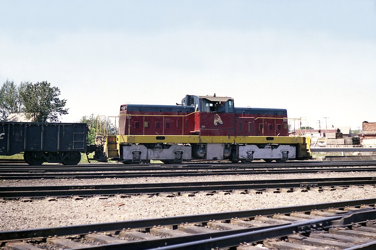 Hopefully someone can provide information on these plant switchers.
This is the Algoma Steel Company "inside the Mill" centre cab #60. I do not know how many of these engines the steel company had, but they were rather hard to catch. I got lucky here. He was out, then back in before I could get another decent shot.
Since this image is over 40 years old, I also wonder if it and others are still employed.
The sprawling complex is now known as Essar Steel, Algoma Inc.