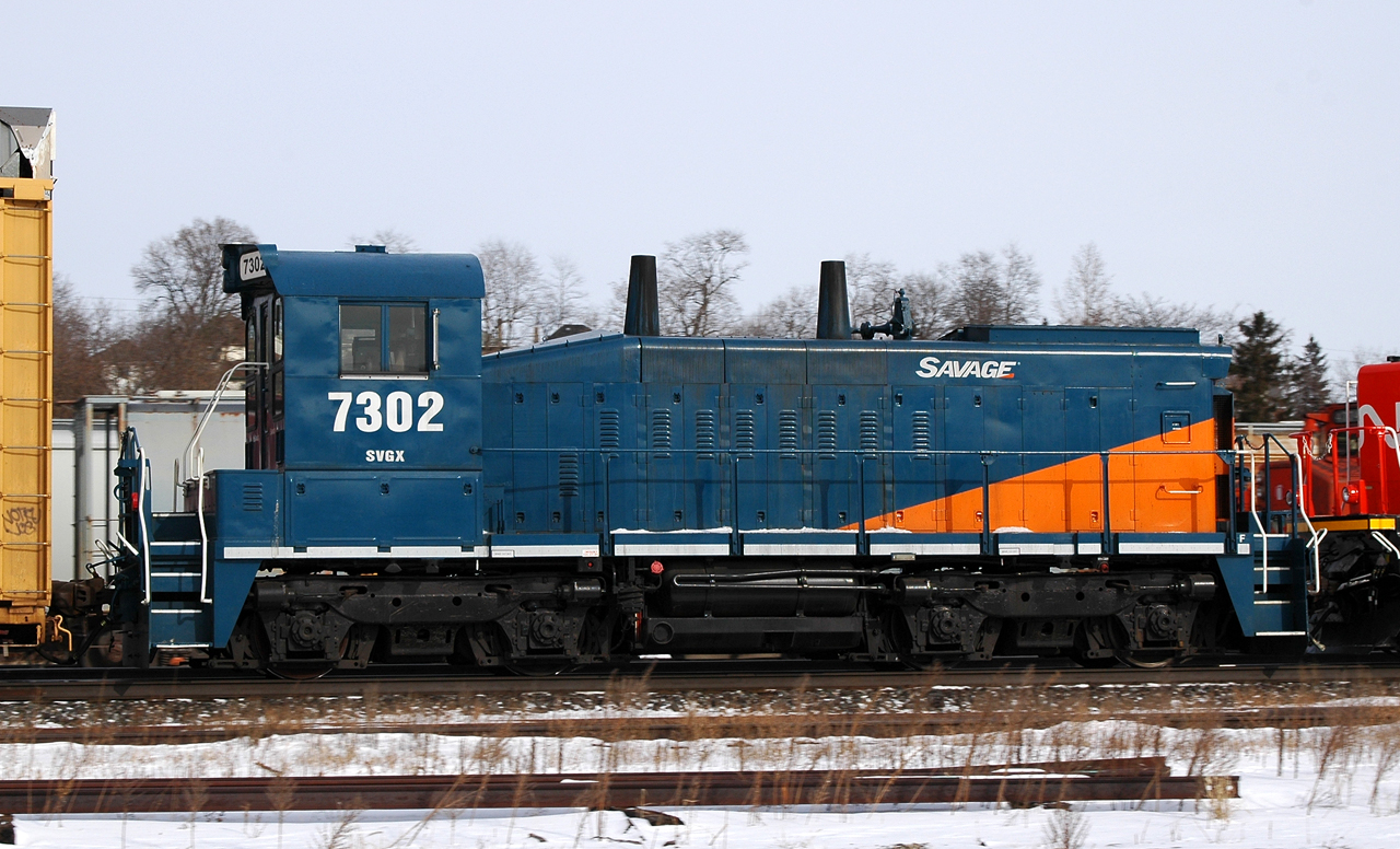 Savage, Inc SW1200RSm 7302 hitches a ride through Brantford on CN 382 back in January of 2014

Built as CN 1368 in April of 1960, it would be rebuilt and numbered in 1987 to CN 7302. Before becoming CANX 7302, and then finally SVGX 7302