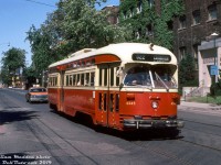 Packed with patrons heading to the annual summer Canadian National Exhibition, TTC PCC 4345 operates on the busy CNE "522 Exhibition West" run between Dundas West Station and Dufferin Loop, heading southbound on Dufferin about to turn onto Springhurst and loop into Dufferin Loop, where 4345 will drop off its packed load a stone's throw away from the CNE's Dufferin Gates entrance. The car is seen passing Canadian General Electric's factories along Dufferin Street: one of which was originally the "Sunbeam Incandescent Lamp Factory", and the other CGE's Carbon and Tungsten Lamp Works / Mazda Lamp branch, both of which were served by rail via trackage in the Liberty Village area.
<br><br>
<i>Bill Madden photo, Dan Dell'Unto collection slide</i>.
