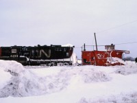 GP9 CN 4493 is powering a plow train, with plow CN 55369 at the head end and looks like another GP9 helping.<br>
<br>The train appears to be halted, with some of the crew on the ground ahead of the plow. <br>
Could be they are considering their next move. Engineer's seat in the GP9 is occupied.<br>
Location mapped is approximate.