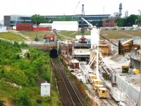 During the summer of 1994, the new CN St. Clair Tunnel is seen under construction, while the old tunnel to the left was still in use under the St. Clair River. The new tunnel officially opened a year later and was later renamed the Paul M. Tellier Tunnel in 2004 for the former CN president and chief executive officer.
