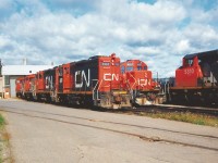 A Saturday morning in 1993 finds CN’s Stuart Street yard shop tracks full of units awaiting their next assignments. The units included from left to right were; SW1200RM’s 7103, 7104, 7307, 7314, GP9RM’s 4127, 4136, 4101, SD40-2(W)’s 5299 and 5310. Also, around the shop facility that day were SW1200RS’s 1355, 1369 and 1375. As well, SW1200RS’s 1359 and 1360 were observed switching the yard. I also have in my notes that there were five active CN cabooses around the yard; 79648, 79853, 79473, 79783 and 79482.