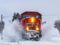 Train 406 heads through the town of Hampton, New Brunswick, after a decent winter snowfall. 