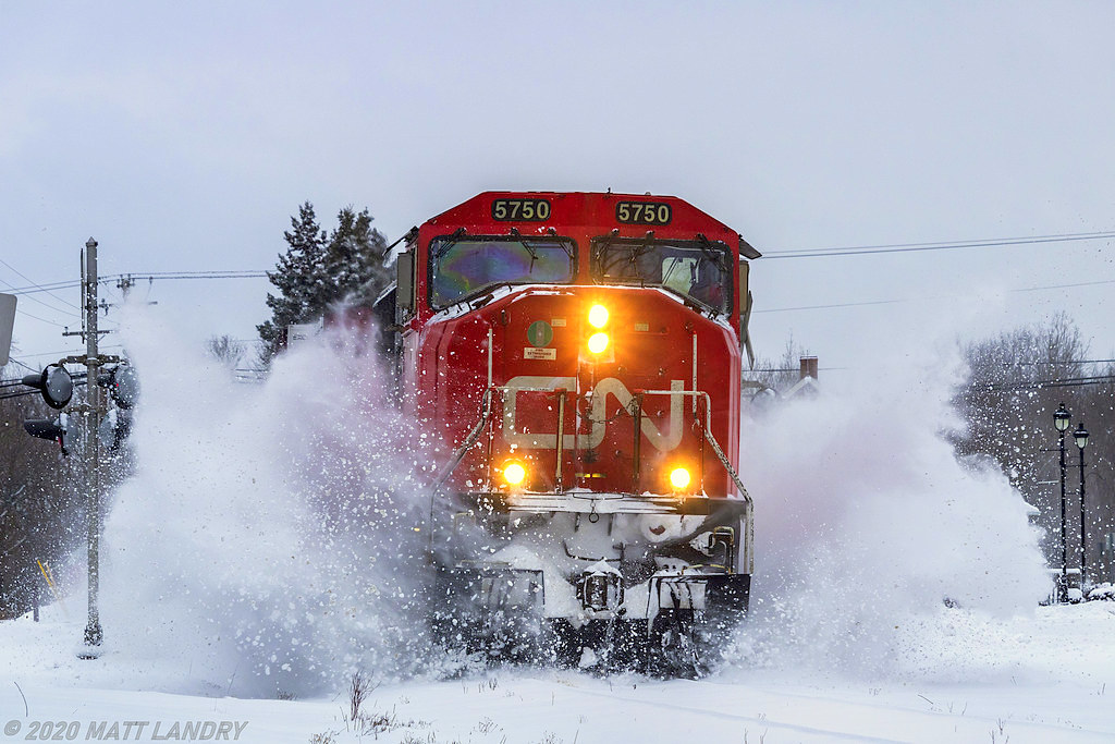 Train 406 heads through the town of Hampton, New Brunswick, after a decent winter snowfall.
