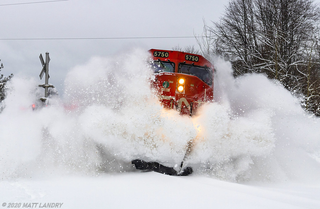 Saturday night the 18th, and for most of the day on the 19th of January, Southern New Brunswick received a healthy dumping of snow. Although not the 80-90cm that Newfoundland got on Friday alone, but my back deck showed about 30cm down in the area. About an hour after the snow finally stopped, train 406 rounds the bend at Rothesay, New Brunswick, hitting a great pile of snow which was left by the plows and mother nature a short time earlier.