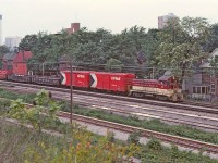 Thanks to Ron Tuff for this image. TH&B 53 doing a routine chore of a transfer from Aberdeen yard to Kinnear yard. Ron noted on the slide that this was near Wentworth St. My memory is a little hazy but the tracks in the foreground perhaps are the CN Hagersville sub and the small interchange that TH&B had with CN. Also at one time there was a freight shed in the area.
