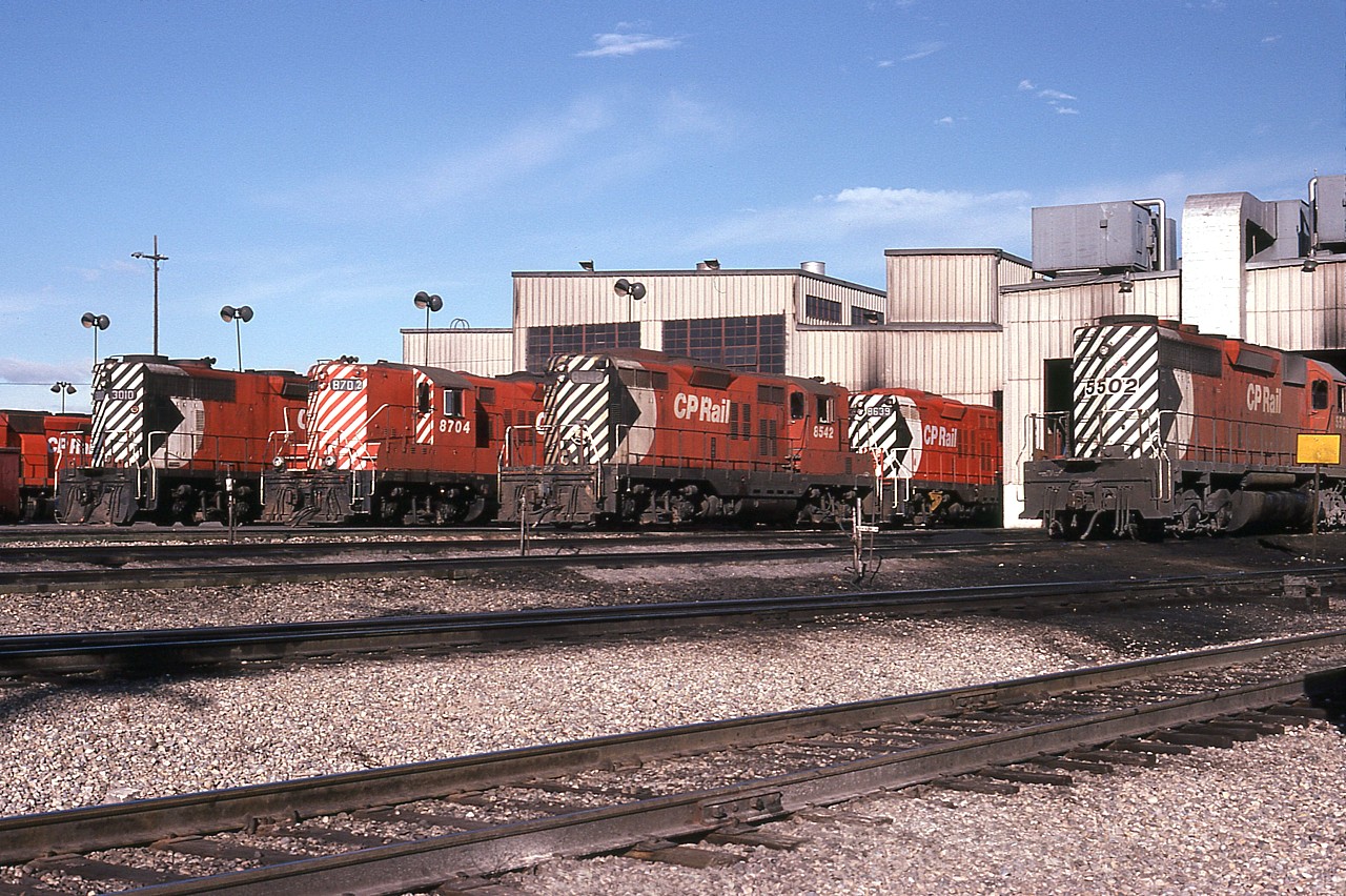 A view in the sprawling Alyth Yard, Calgary; some years ago. Interesting assortment of power. It must be my eyes playing tricks but that old GP9 with '8704' on the cab seems to read '8702' on the number board.:o) And of interest too is the GP38 over on the far left, #3010. This photo is 42 years old but that engine is still on the roster, and I guess, still rolling.