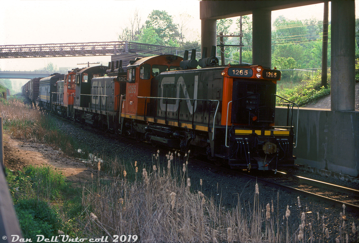 Heading through the Don Valley bound for Downtown Toronto, fresh-looking CN SW1200RS 1265 leads sisters 1207 and 1249 on a southbound transfer run (KO27?) down the Bala Sub and seen passing under Don Mills Road. Trailing is a VIA 6600-series F9B, likely deadheading back to Spadina Roundhouse after receiving repair work at CN's MacMillan Yard that Spadina may not have been able to perform.J. Bryce Lee photo, Dan Dell'Unto collection.