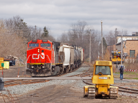 <b>Nothing runs like a Deere.</b> Yet, some days, nothing runs on time.... CN took over operations of the Guelph Sub from GEXR a few months prior to this shot being taken, and over the first few months 431 would be delayed leaving MacMillan on multiple occasions, pushing operations into the favorable daylight hours. <br><br>
On this day, I was moving out of my house in Guelph. After a late start to my day, few other contributing members (big thanks goes out to them!) of this site informed me they were chasing a daylight 431 which was on the Halton sub, west bound and down. Quickly deeming I was too "tired" to chase, I opted for the "sit and wait" strategy. After hearing the train was clear of Georgetown (about 40-60 minutes from Guelph by rail) I drove to Alma Street, Timmies in hand, set up here and waited amongst the birds, bushes and dog walkers. I remember having to wait longer then I thought, which was annoying since I was not prepared for the bitterly cold wind that was unusual (and frankly unwelcome) for later April. After seeing it was one big GE with 50-60 cars, if memory serves, made sense the assault on the Acton hill would've been a bit slower then normal. With new updates from the aforementioned buddies giving chase, I knew the train was close. <br><br>
What happened next was probably one of the more humorous displays of railfanning I've witnessed to date. I could see/hear the crossing get activated on Edinburg Street (background of the shot above). And just as the nose of the ex-ATSF GE came into view, two railfans ran into view from out of nowhere, just in time to get their shots. After clearing the crossing, they disappeared back to the chase vehicle. Then as 431 approached Alma Street (in the foreground), two different railfans come into view just in time for a shot, as evident by the railfan in action on the right side of my shot above! After couple of quick waves to them, laughing the entire time at the train paparazzi that had just taken over midtown Guelph, I fired off the shot above just in time for a fortunate mid-strength sucker hole. <br><br>
This humorous story aside, the reason this shot recently came to mind for me is, after passing Alma Street, I discovered that this angle is no longer possible. Metrolinx has put up a slew of fences in Guelph recently including along the well known <a href="http://www.railpictures.ca/upload/well-as-kent-brockman-in-the-simpsons-once-capitulated-during-an-alien-invasion-on-the-simpsons-i-for-one-welcome-our-new-railway-overlords-and-i-guess-i-feel-the-same-way-the-goderich-exeter">Kent Street.</a> I'm happy to see that a few other Guelph railfans have used this angle, including Jacob Patterson with the <a href="http://www.railpictures.ca/upload/thanksgiving-weekend-was-warm-this-year-and-here-is-431-headed-back-to-its-home-terminal-of-stratford-passing-through-ex-cn-guelph-jct-not-much-for-fall-colours-this-year-maybe-next">same train under GEXR</a> as well as Steve Host  <a href="http://www.railpictures.ca/?attachment_id=24171">reflecting on this location as well</a>.
</html>
