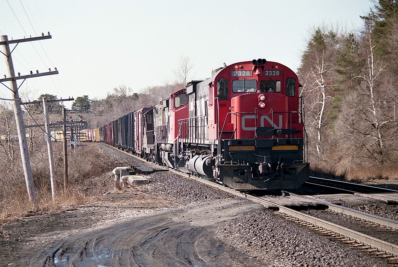 Down at Bayview CN #436 is waiting for traffic to clear off the Dundas sub before heading eastward toward Toronto.
Power is CN 2328, 2555 and 4414.  I was always a fan of the big M-636s, but never really did not see all that many of them leading.
The 2328 was retired by 1998 according to the trackside guide.