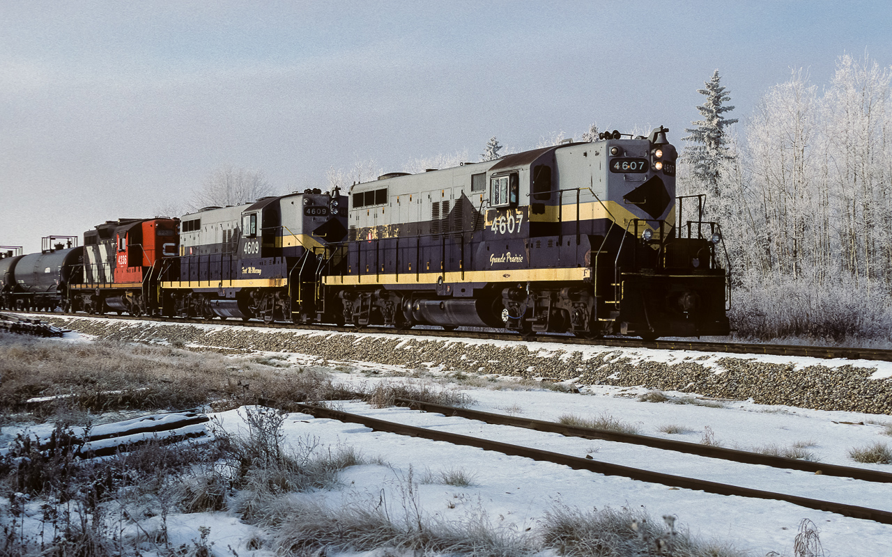 I have called this train 836. But, starting in 1986 (or 85), the Coronado Sub. became MBS territory and 584 and 836 were no longer listed in the employee time table. I have no knowledge what this movement may have been called with the change to MBS, so, I'm going with 836 or the Jet Fuel train. Here it is at the Kerensky siding, they are just about ready to stop to get the connecting track switch and then proceed onward to the Cold Lake airforce base. It is a solid string of tanks today with Cab 79822 bringing up the rear. Another lineup of elephant style units, which, the exNAR power easily created with CN's long hood forward GP9's (the 4236 is the trailing unit). An early frosting of the trees makes the season appear much later than Nov.10th. Time of this photo is 11:30.