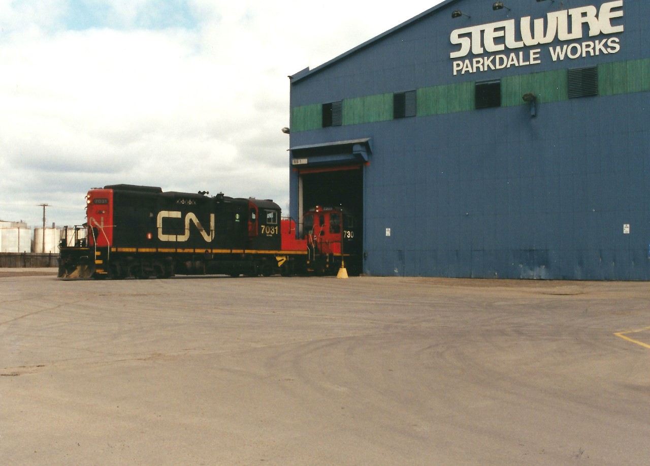 CN GP9RM 7031 and SW1200RSM 7305 are reaching deep into the Stelwire Parkdale Works in Hamilton's expansive industrial core as they service the facility. Being unfamiliar with the area at the time, it was hard to pin point the map to the exact location where the photograph was taken. Also, any information on how much this industrial trackage has changed since or even if it's still there today as well as any additional information would be welcome and appreciated.