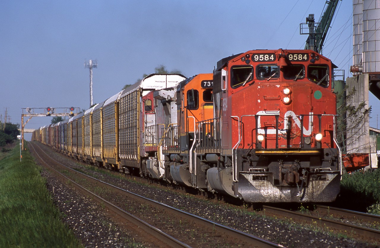 Looking at the satellite imagery for this location, it looks like this area has changed dramatically!  In this scene CN 275 is about to cross Mississauga Road on the western edge of Brampton. The type of power assigned to 275 has also changed significantly in the last 16+ years. GP40-2W CN 9584, SD40-2 BNSF 7319, and B40-8W BNSF 567 are a fine sight to behold as they race westward in the evening light.