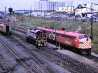 The switching of CP's eastbound Canadian is well underway at Sudbury, Ontario on July 22nd, 1969. The inbound train # 2, arrived with an A-B-A set of F units. Per CP's practice at the time, the middle unit was set off at Sudbury. It would return west on that nights # 1. I never understood why CP would not simply set off the trailing unit, and add it back to the westbound train in the trailing position, rather than go through the extra work of cutting out the middle unit and adding it back in to # 1 in the middle position. This seemed like a lot of extra work. The yard crew would eventually take the B-unit to the roundhouse. From left, the units are: 1904, 7091, 1410 and 1417.








