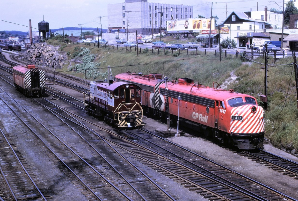 The switching of CP's eastbound Canadian is well underway at Sudbury, Ontario on July 22nd, 1969. The inbound train # 2, arrived with an A-B-A set of F units. Per CP's practice at the time, the middle unit was set off at Sudbury. It would return west on that nights # 1. I never understood why CP would not simply set off the trailing unit, and add it back to the westbound train in the trailing position, rather than go through the extra work of cutting out the middle unit and adding it back in to # 1 in the middle position. This seemed like a lot of extra work. The yard crew would eventually take the B-unit to the roundhouse. From left, the units are: 1904, 7091, 1410 and 1417.