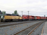 A set of power including CP SD40-2 5428, SD9043MAC 9108, SD40-2 5928 and two other GE AC4400CW units move around near the station at Sudbury (note city water tower in the background). CP 5428 is a former Missouri Pacific/Union Pacific unit CP had purchased secondhand from GATX (after having leased it through them). The 5400-series were CP's secondhand SD40 number series, which included units originally built for railroads including MP/UP, KCS, QNS&L and NS/SOU.