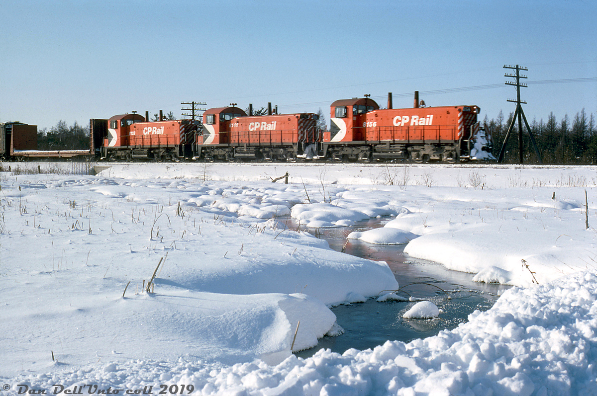 Heading eastbound on the Galt Sub, CP #50 with a trio of "pups" (SW1200RS units, today 8156, 8141 & 8123) pass by a small stream at Puslinch in this quaint winter scene. As per photos and information posted by others, the little SW1200RS units were regulars on this run, often in groups of 3-5 running "elephant style" to Toronto.

(I'm not sure on the exact location, but this looks to be shot from Concession Road 7 by the crossing. Perhaps one of the regulars can confirm?)

Reg Button photo, Dan Dell'Unto collection.