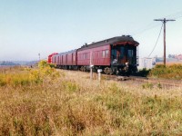 In September 1997, CP had officially unveiled its new beaver shield heritage logo on GP38-2 3069. To commemorate the new scheme, the railway sent 3069 on a six-week transcontinental and trans-border tour to show-off the colors along with two display coaches as well as a private car, dubbed the "Logo Train." The train was ordered from Toronto during the early morning of Saturday September 27 and made a very quick trip across the Galt and Windsor Subdivisions to Windsor, where it would be put on display that day. The following day the train was displayed at CP's Quebec Street yard in London along with freshly washed STL&H SD40-2 5654. 

Here 3069 with the "Logo Train" is pictured hustling westbound at the east siding switch at Wolverton, just west of Ayr, back when Wolverton was just a siding in between farm fields.
