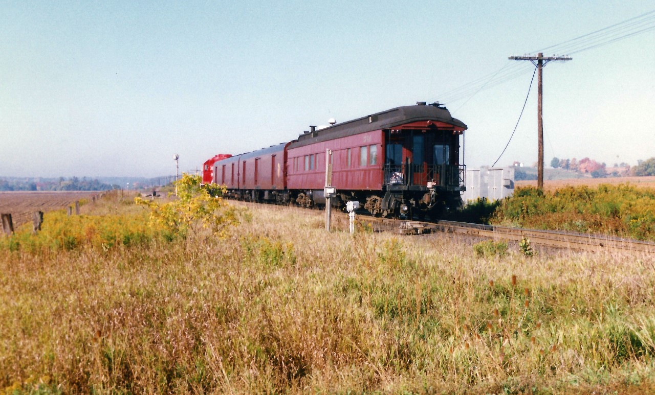 In September 1997, CP had officially unveiled its new beaver shield heritage logo on GP38-2 3069. To commemorate the new scheme, the railway sent 3069 on a six-week transcontinental and trans-border tour to show-off the colors along with two display coaches as well as a private car, dubbed the "Logo Train." The train was ordered from Toronto during the early morning of Saturday September 27 and made a very quick trip across the Galt and Windsor Subdivisions to Windsor, where it would be put on display that day. The following day the train was displayed at CP's Quebec Street yard in London along with freshly washed STL&H SD40-2 5654. 

Here 3069 with the "Logo Train" is pictured hustling westbound at the east siding switch at Wolverton, just west of Ayr, back when Wolverton was just a siding in between farm fields.
