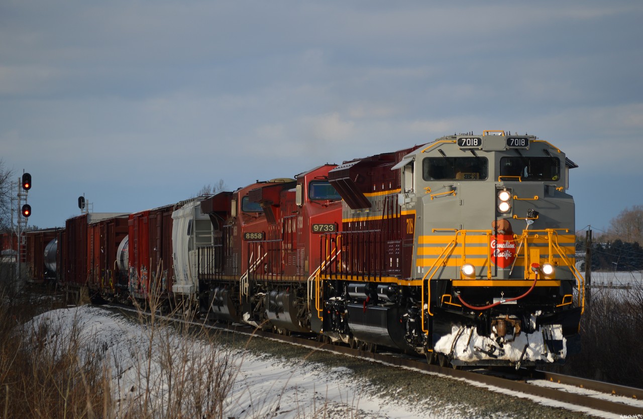 CP 7018 South has just cut away from their tail end setoff at Spence and is pulling down to the 10th line while the Conductor gets a ride around to the head end. Looking fresh and really sharp, 7018 is one of 10 maroon and grey heritage units (7010-7014 in script, 7015-7019 in block lettering), just being delivered to CP along with 7019 to complete the series on Dec 27th.