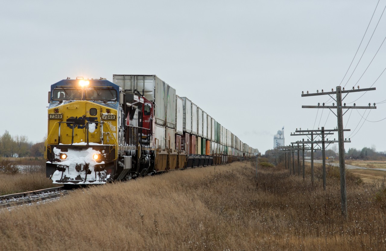 A detouring train 114 is seen on the former CNoR secondary main line at Warman SK. In less than a mile the train will swing on to the Warman Sub and head down to Saskatoon to re-join the main.