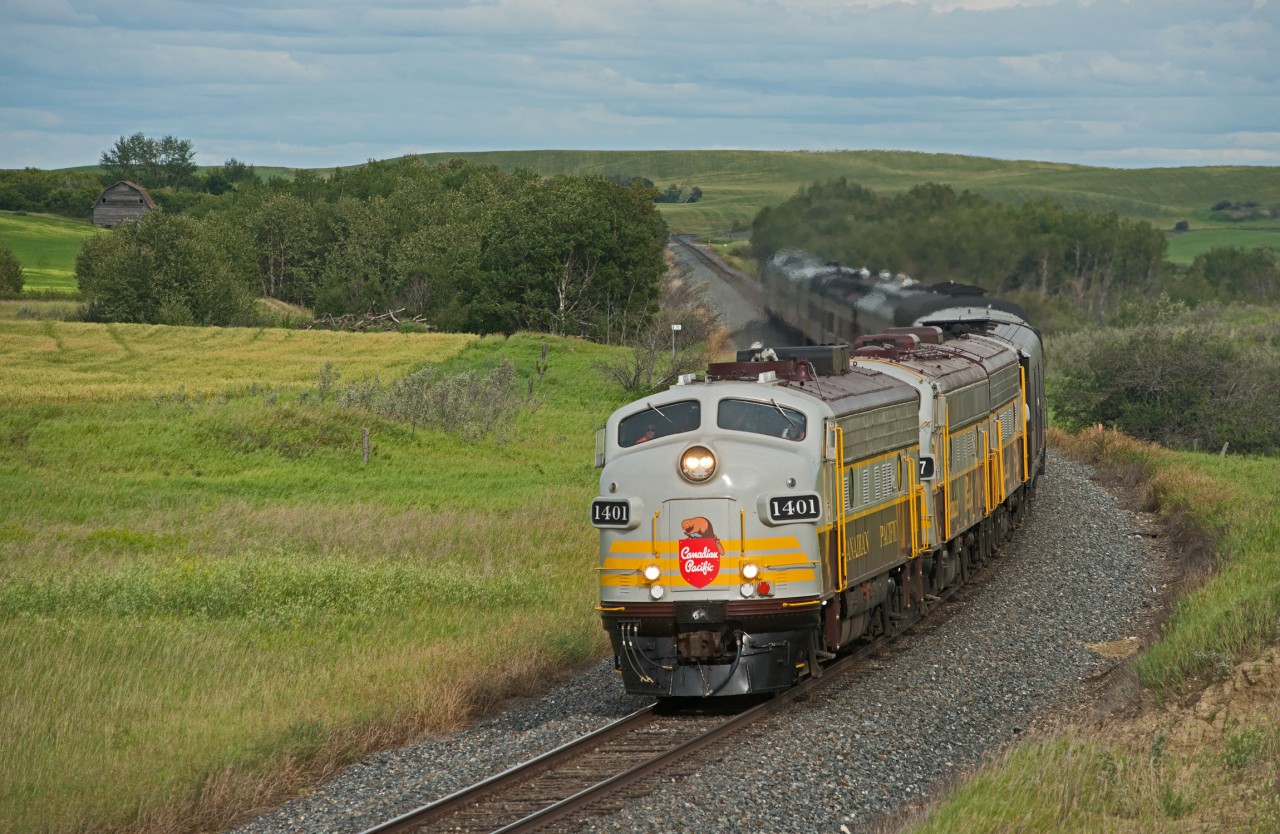 This past August CP's business train made a quick spin through Saskatchewan with Keith Creel aboard showing a group of VIPs around. The trio of F's is seen here just east of Biggar with the hills of Keppel visible in the background. The train would tie down in Wilkie for the night and a helicopter would take the passengers back to Saskatoon.