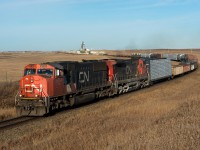 CN 114 rounds the bend at Oban Saskatchewan. Oban is the first station name west of Biggar on the Wainwright Subdivision. CP's Wilkie Sub is visible across the highway in the background. 