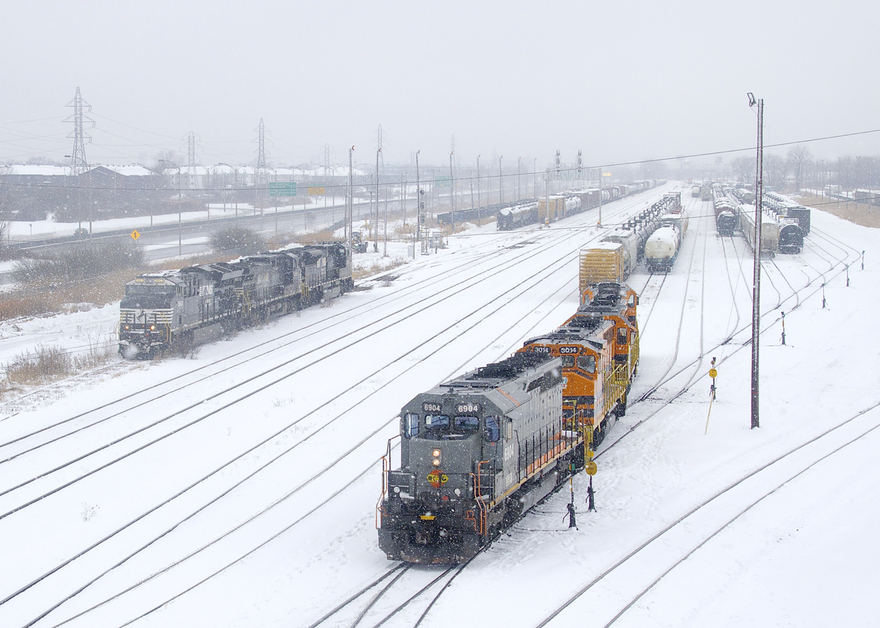 QGRY 6904 is leading SLR 394 which is putting its train together at right as CN 543 with borrowed NS power (NS 3660, NS 4039 & NS 7295) makes a move at CN's Southwark Yard on a snowy afternoon.