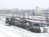 CN 543 with NS 7295, NS 4039 & NS 3660 is heading west on CN's St-Hyacinthe Sub as it does work at Southwark Yard on a snowy afternoon.