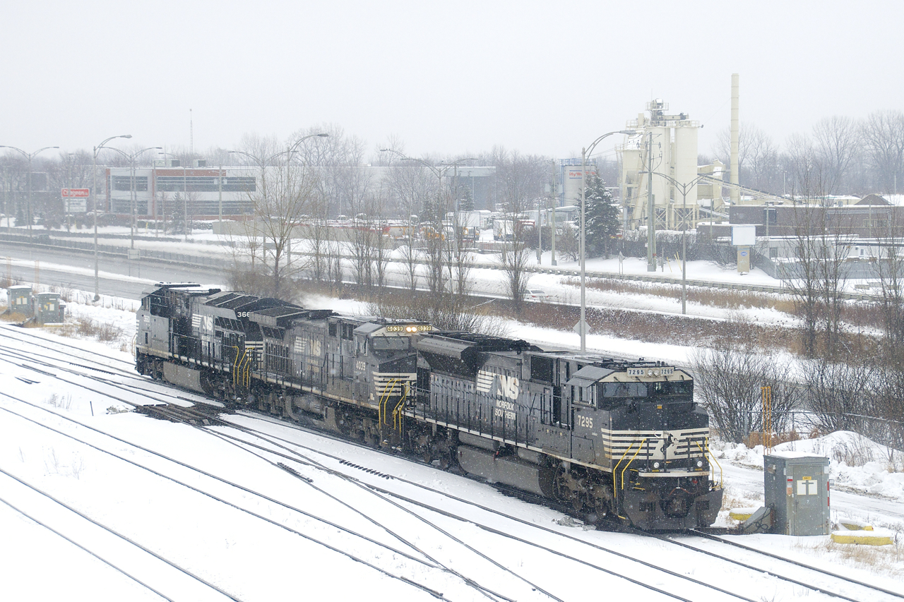 CN 543 with NS 7295, NS 4039 & NS 3660 is heading west on CN's St-Hyacinthe Sub as it does work at Southwark Yard on a snowy afternoon.
