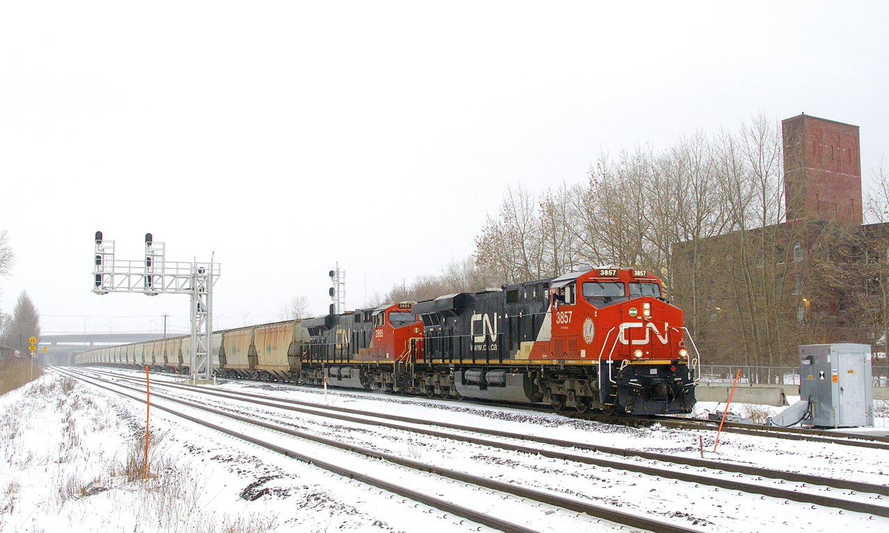 After not running for quite a number of months, the second CN B730 to run in about a week heads east after changing crews at Turcot Ouest on an icey morning as the engineer offers a friendly wave. This train has 203 potash loads for Saint John, New Brunswick and is powered by four GE products, with CN 3857 & CN 2885 up front, CN 2982 mid-train and CN 3866 on the tail end.