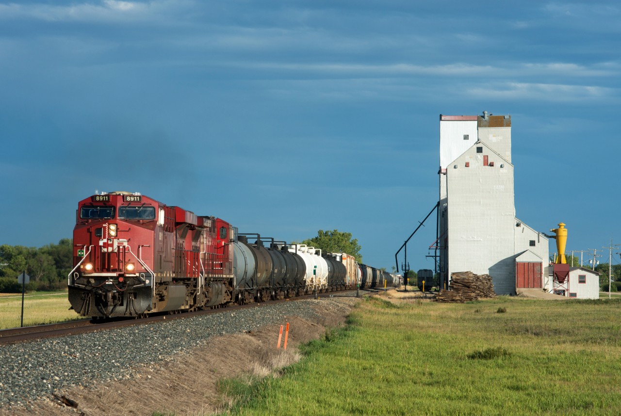 Set against some decent storm light, CP 8911 North passes a pair of elevators at Lang Saskatchewan.