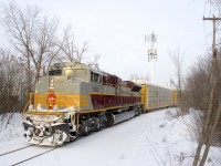 Heritage unit CP 7012 brings up the rear of CP 112, which is stopped on the spur that leads from CP's Vaudreuil Sub to the Lachine IMS Yard. CP 7012 and five autoracks have been tied down just west of the yard, while the intermodal portion of the train gets broken up.