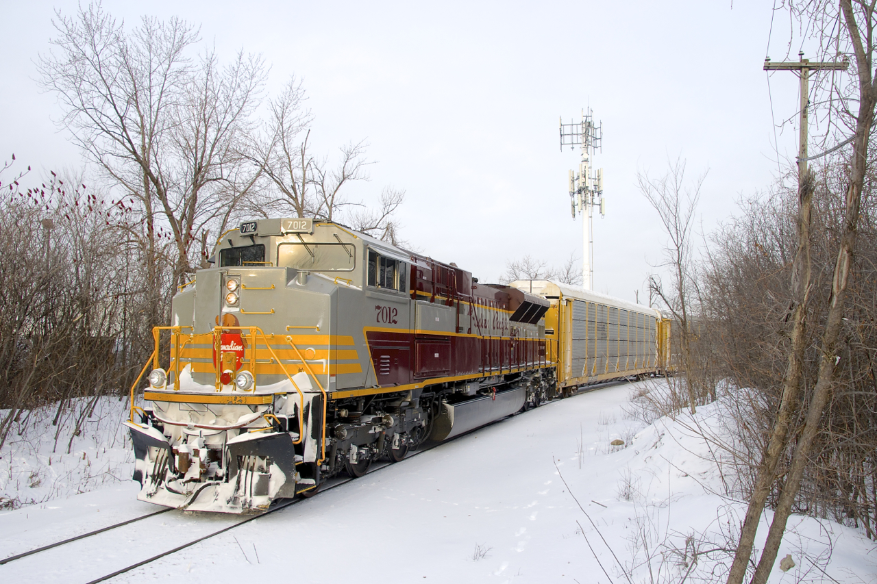 Heritage unit CP 7012 brings up the rear of CP 112, which is stopped on the spur that leads from CP's Vaudreuil Sub to the Lachine IMS Yard. CP 7012 and five autoracks have been tied down just west of the yard, while the intermodal portion of the train gets broken up.