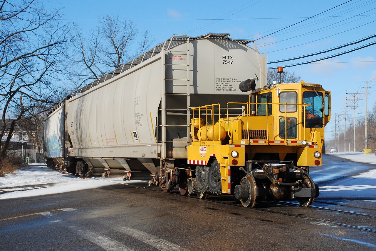 Some were wondering what hot rail action was happening on the Burford Spur these days.  Sadly it's still just the Track Mobile that typically works one day a week hauling hoppers to and from Ingenia.  I had yet to bother to get a decent shot of the current motive power so since the sun was shining and I was in the 'hood I waited a few minutes for them.  More surprising is that I wasn't the only one that had the same idea!  Here, Allied's Track Mobile is crossing Greenwich Street with three loads for the plant.  Three is probably the most it can pull, even though it's advertised to pull twelve.  Unless it's something extraordinary I promise I won't post another photo of the track mobile Steve...
