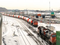 CN X148 is meeting windmill train CN X319, which is about to depart Turcot Ouest with a fresh crew. After setting off most of its train at Taschereau Yard, CN X148 is continuing towards the Port of Montreal with CN 2959 & CN 2816 for power. CN X319 has CN 3158 solo and 50 windmill towers.