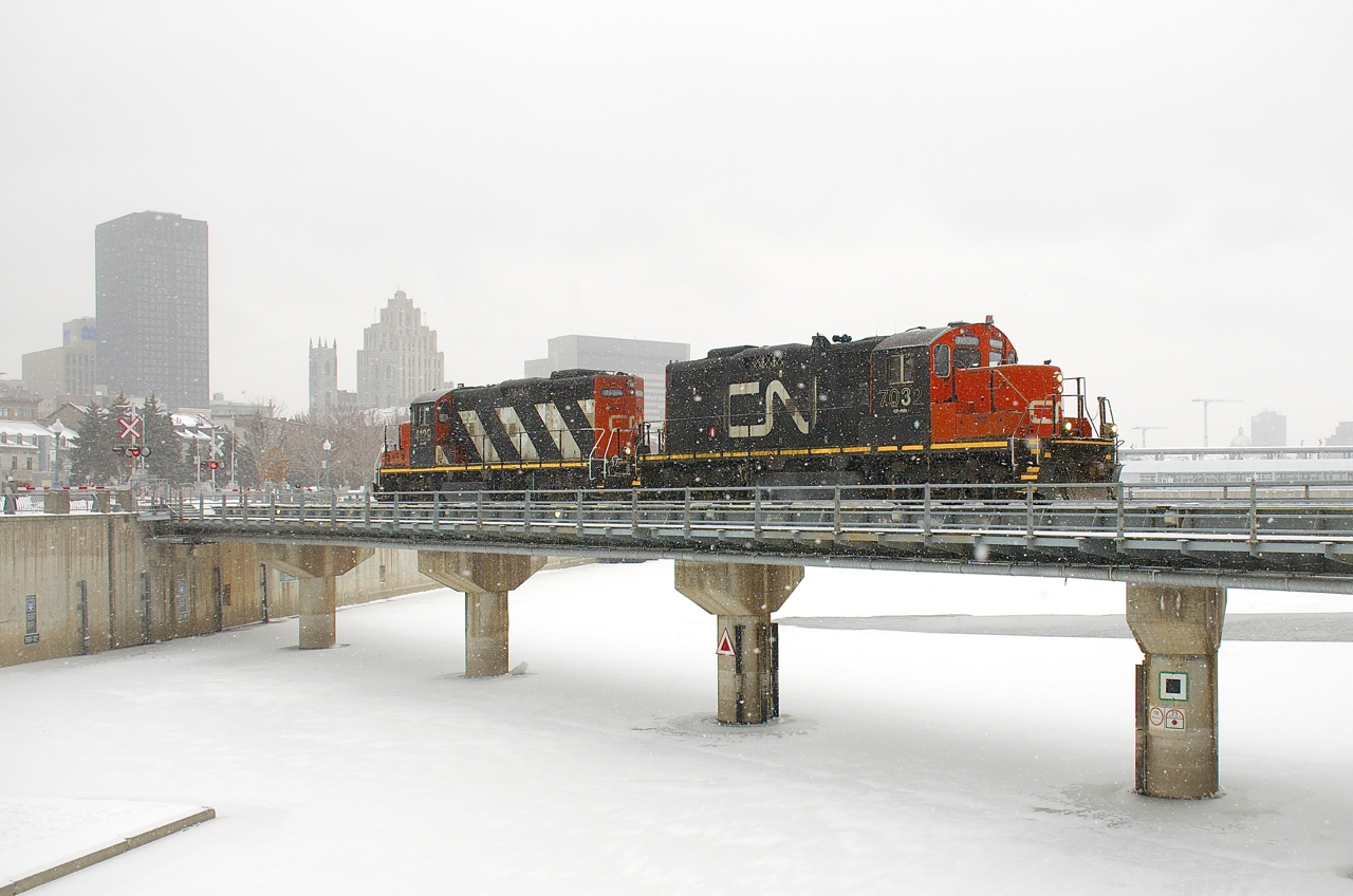 CN 7032 & CN 4129 are leaving the Port of Montreal light power on a snowy day.