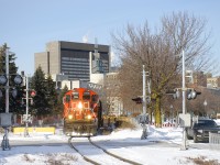 CN 4129 & CN 7032 are leading a baretable move out of the Port of Montreal as they approach one of the many crossings in this area.