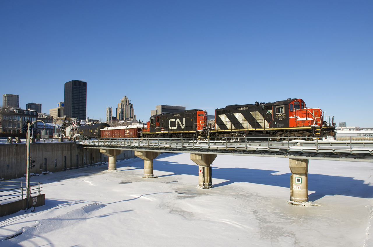 CN 4129 & CN 7250 are shoving a transfer into the Port of Montreal as they cross over the frozen Lachine Canal where it empties into the St. Lawrence River.
