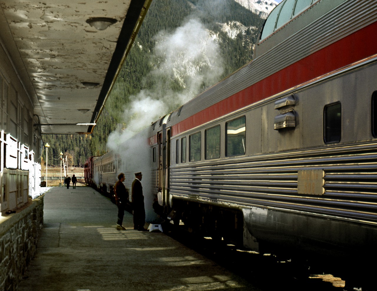 During The eastbound Canadian's stop and crew change in Field a carman discusses a steam leak with a sleeping car porter