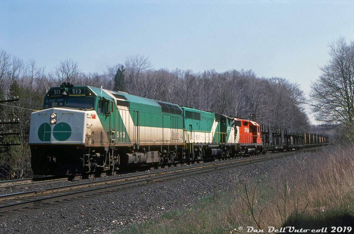 In the late 70's and into the 80's, power-short CP found a convenient source of extra power in the form of under-utilized GO Transit commuter units. Instead of sitting around Guelph Junction or Willowbrook after working a week of 9-to-5 commuter service hauling passengers on the Milton or Lakeshore commuter lines, CP would often round up a bunch of GO units on Friday evening and send them on their merry way for a Toronto-Montreal-Windsor-Toronto weekend trip hauling 900-series freights, often with a CP unit or two thrown in for good measure. As long as they were back in time for Monday morning rush hour, the motive power guys at CP wouldn't get any angry phone calls from GO wondering where their commuter power was.

Here, GO Transit F40PH 513, GP40-2W 700 and CP GP35 5025 handle train #903 westbound through Campbellville on the Galt Sub, with no shortage of CP autoracks on the head-end. GO power was still being leased by CP in the late 80's and in the early F59PH era when some of GO's "40" series power was surplus. CP even managed to send a few GO units as far west as Alberta and Saskatchewan. Eventually the old GO fleet was dispersed to CN, Amtrak and EMD, and that was the end of CP leasing GO power on weekends (GO elected not to lease CP any of their brand new F59's to run ragged in weekend freight service).

Reg Button photo, Dan Dell'Unto collection slide.
